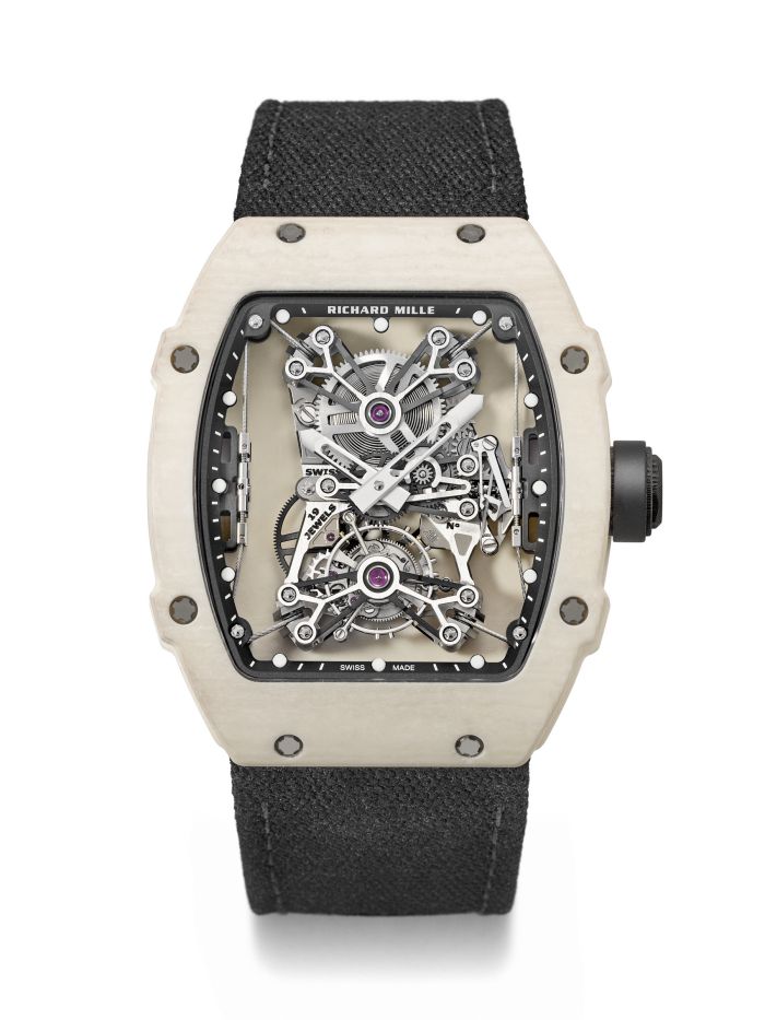 Un orologio di lusso Richard Mille Nadal con cassa bianca di forma tonneau, movimento scheletrato intricato visibile e cinturino in tessuto nero, raffigurato su sfondo bianco.