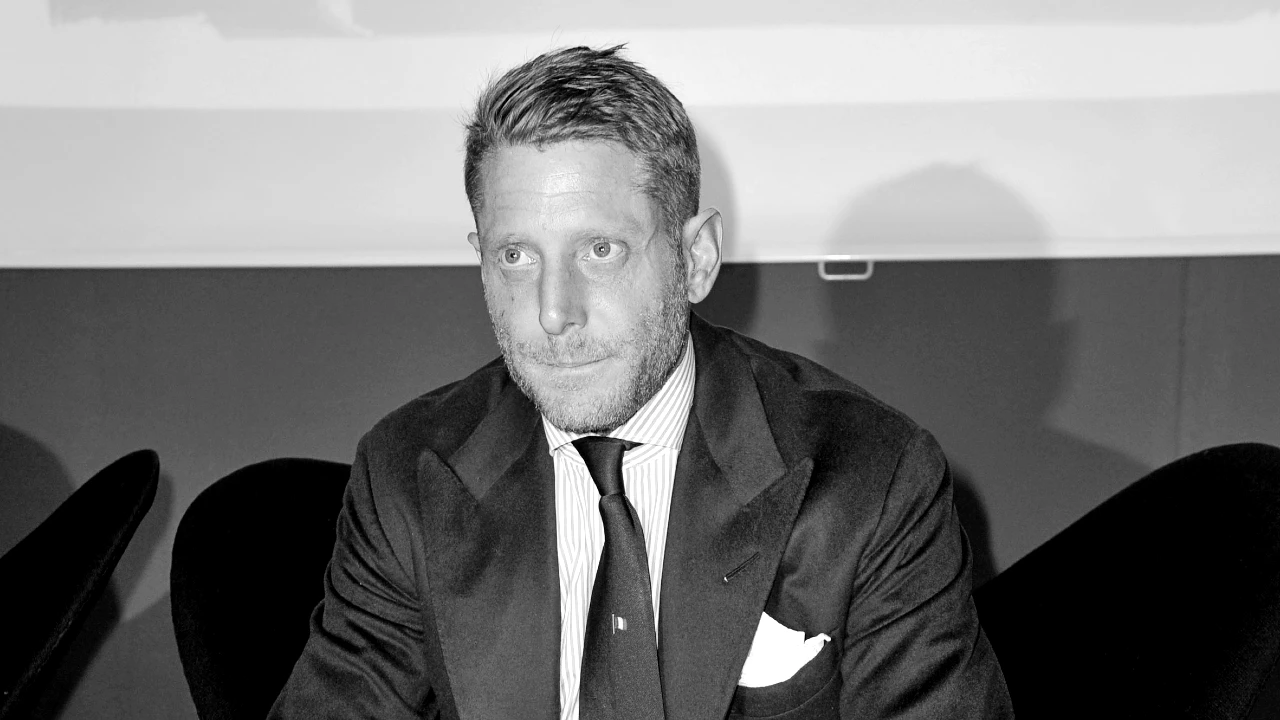 Foto di Elkann in bianco e nero in giacca e cravatta, collegato al tema della sua successione