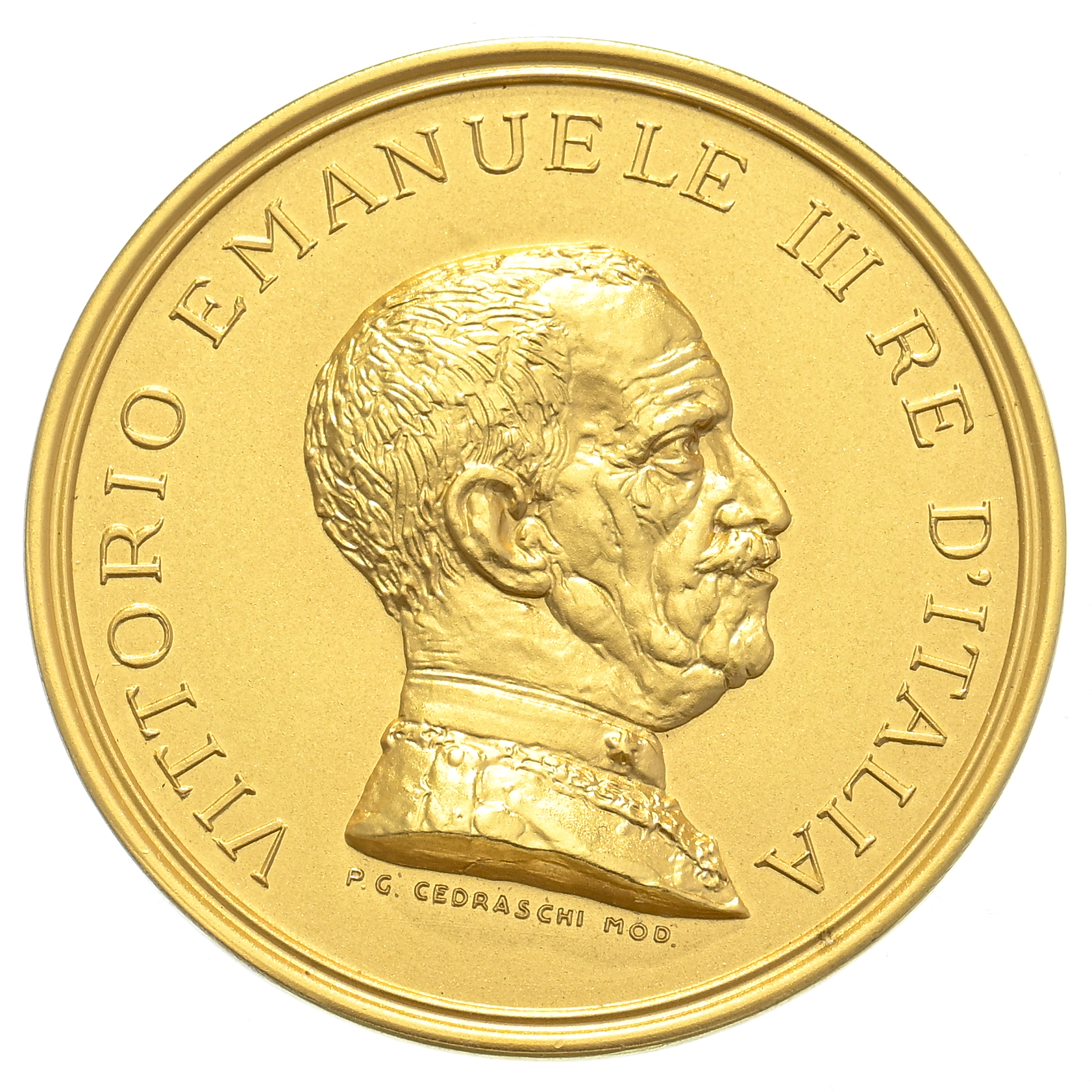 Moneta d'oro della serie delle medaglie di Savoia con il profilo di un uomo con capelli corti e baffi, rivolto verso destra, circondato dall'iscrizione "VITTORIO EMANUELE III RE D'ITALIA". Il nome dell'artista compare sotto il ritratto.