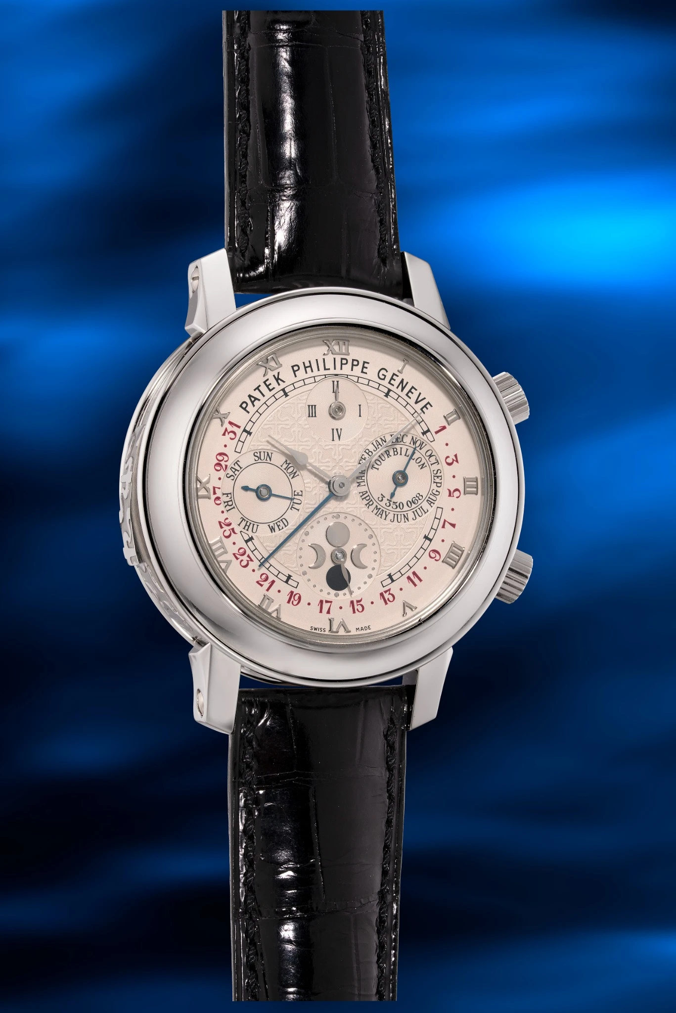 Un lussuoso orologio da polso Patek Philippe Hong Kong con quadrante bianco, contatori multipli, cassa argentata e cinturino in pelle nera, su uno sfondo blu vibrante e astratto.